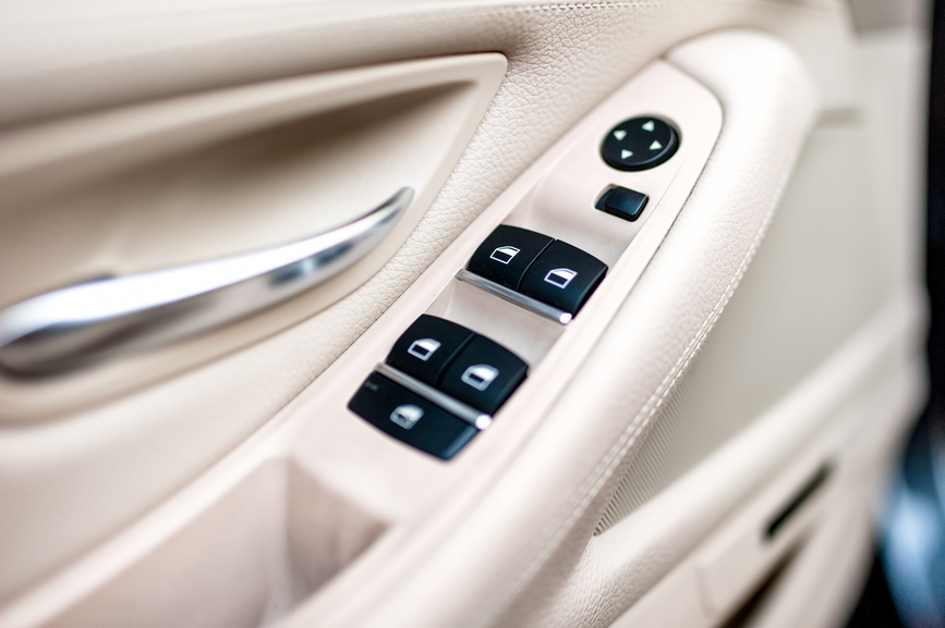 car leather interior details of door handle with windows control