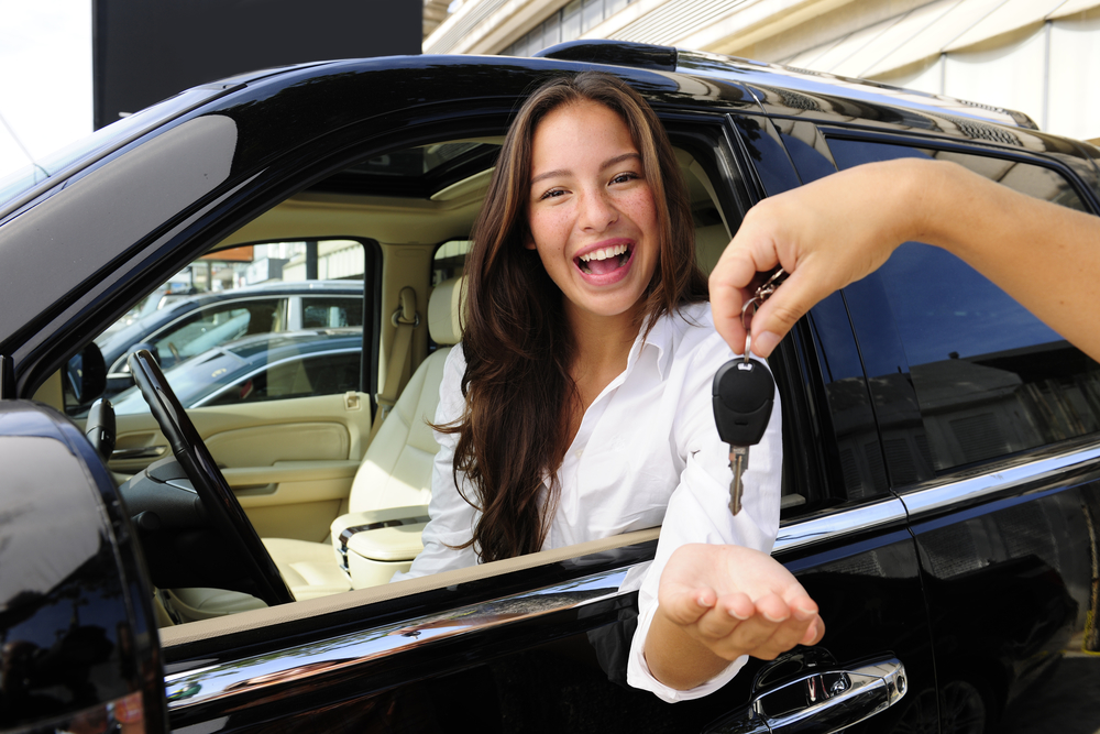 businesswoman receiving keys of her new off-road car