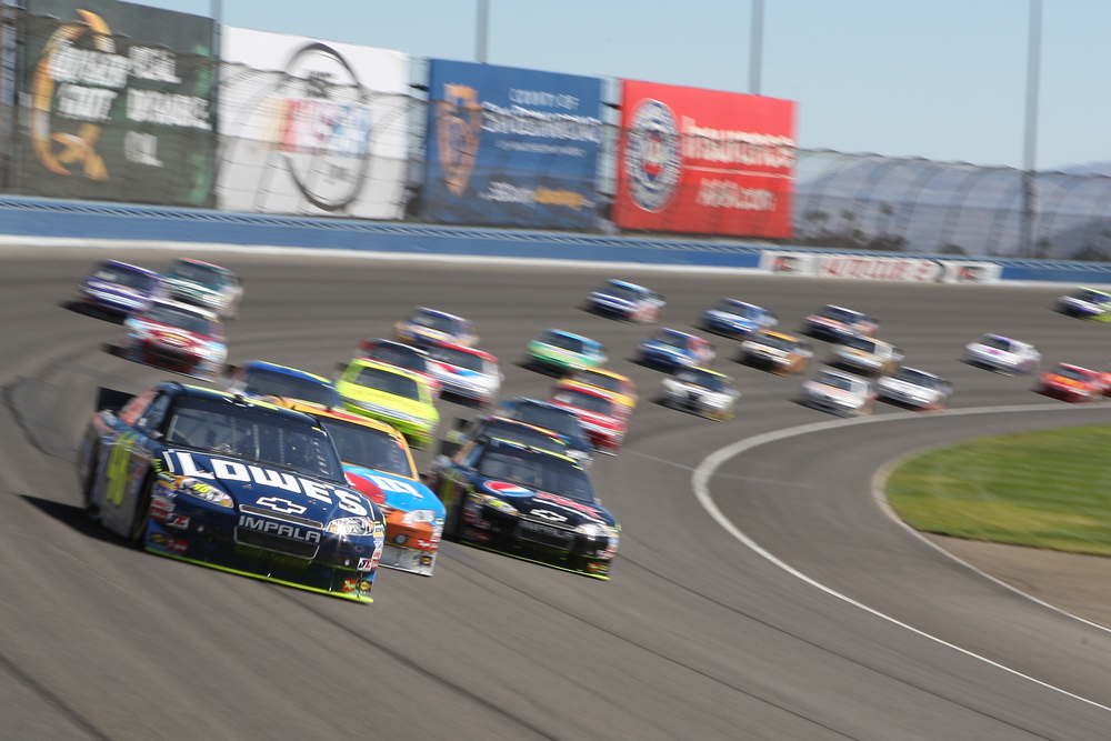 FONTANA, CA. - OCT 10: Sprint Cup Series driver Jimmie Johnson in the Lowe's #48 car leads out of turn 2 during the Pepsi Max 400 on Oct 10 2010 at the Auto Club Speedway.