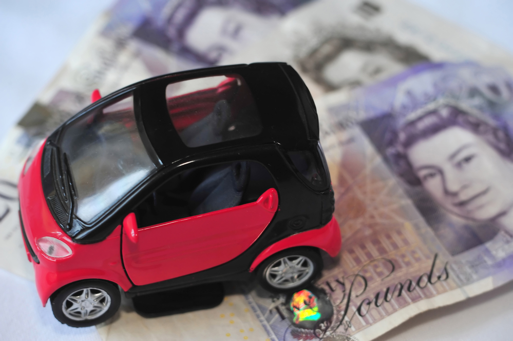 Toy smart car on British Pounds