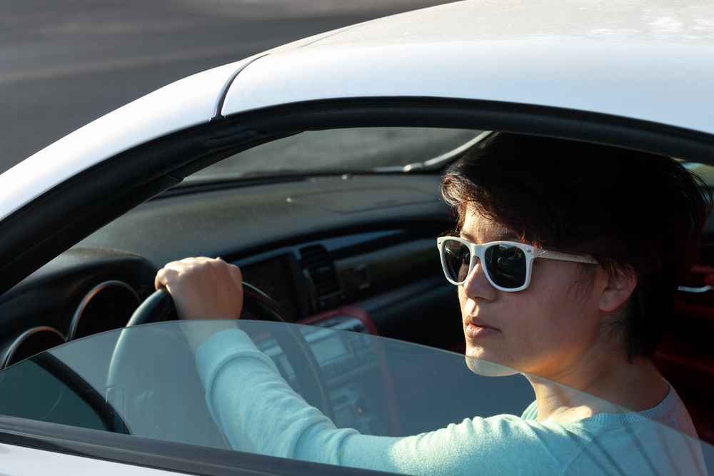 Woman Driving a Sports Car