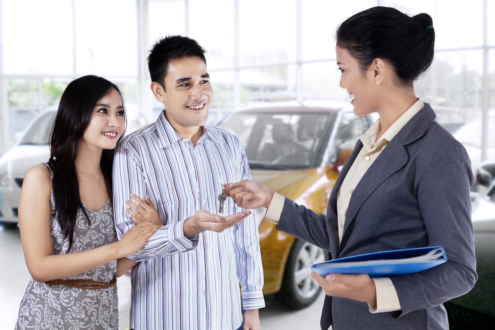 Happy couple receive a car key