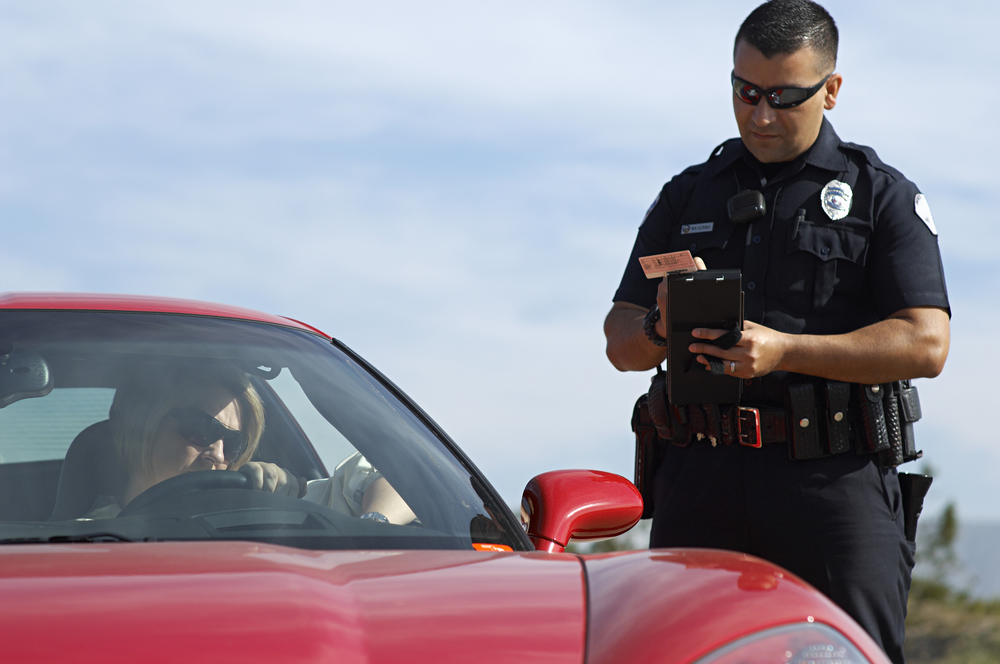 Police Officer Writing A Ticket On Duty