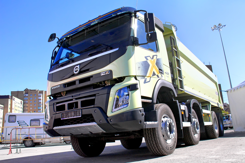 reen Volvo FMX dump truck exhibited at the annual Autosalon Motor show.