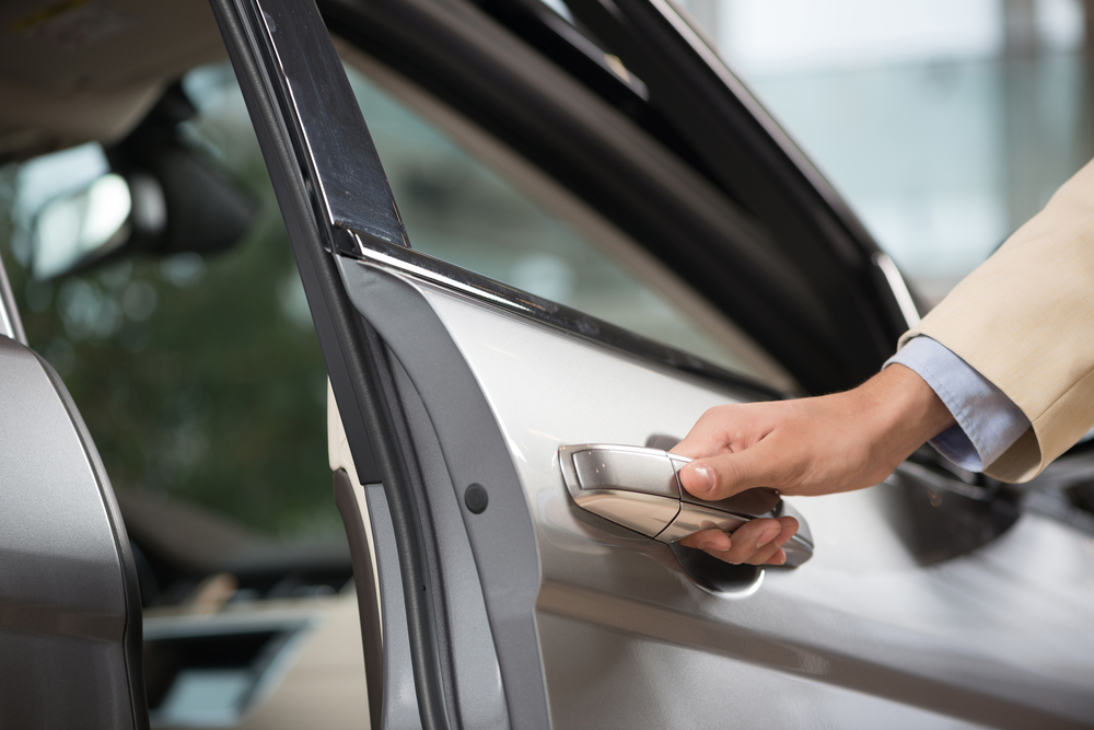 Close up of human male hand opening car door