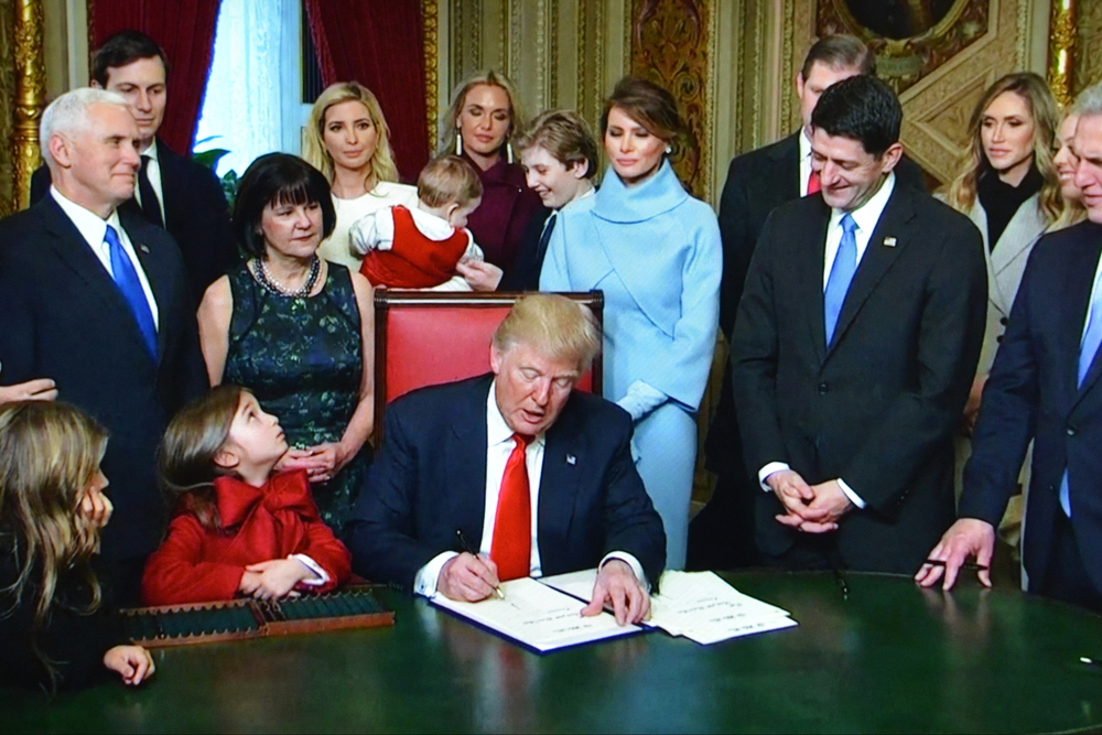 Washington DC, USA - January 20, 2017: An internet live news channel streams President Trump signing executive orders following his inauguration.