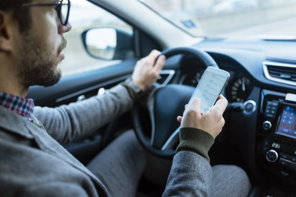 Man driving and texting