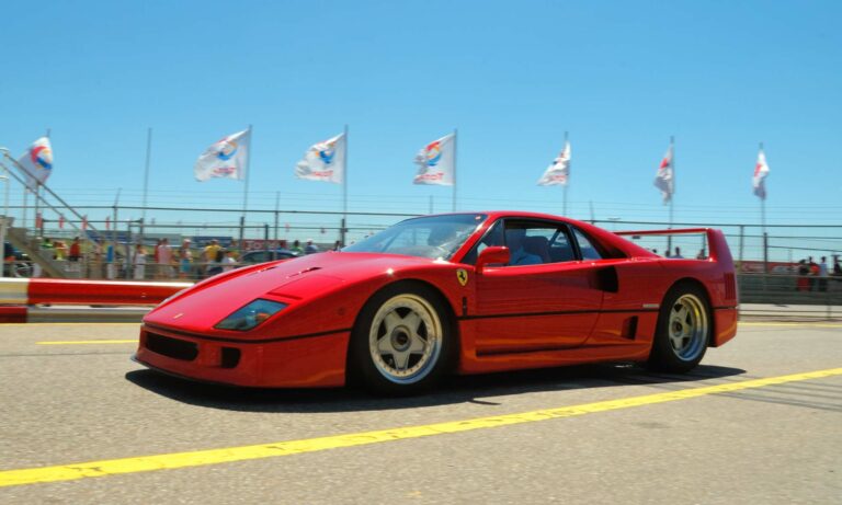 A red Ferrari F40 driving around a race track.