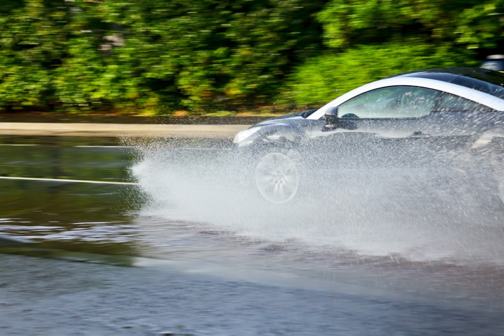 car-hydroplaning-on a flooded street