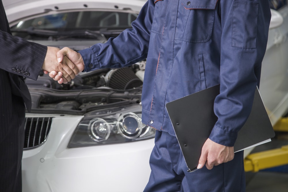 mechanic and businessman negotiate