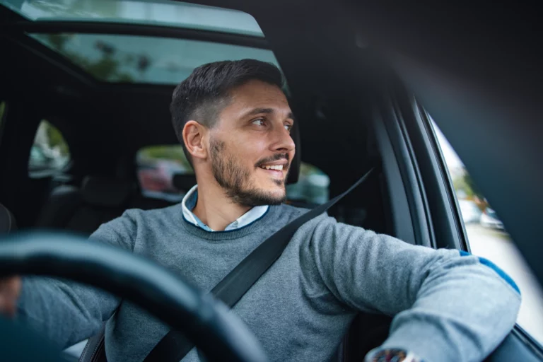 Businessman Looking Away While Driving His Car