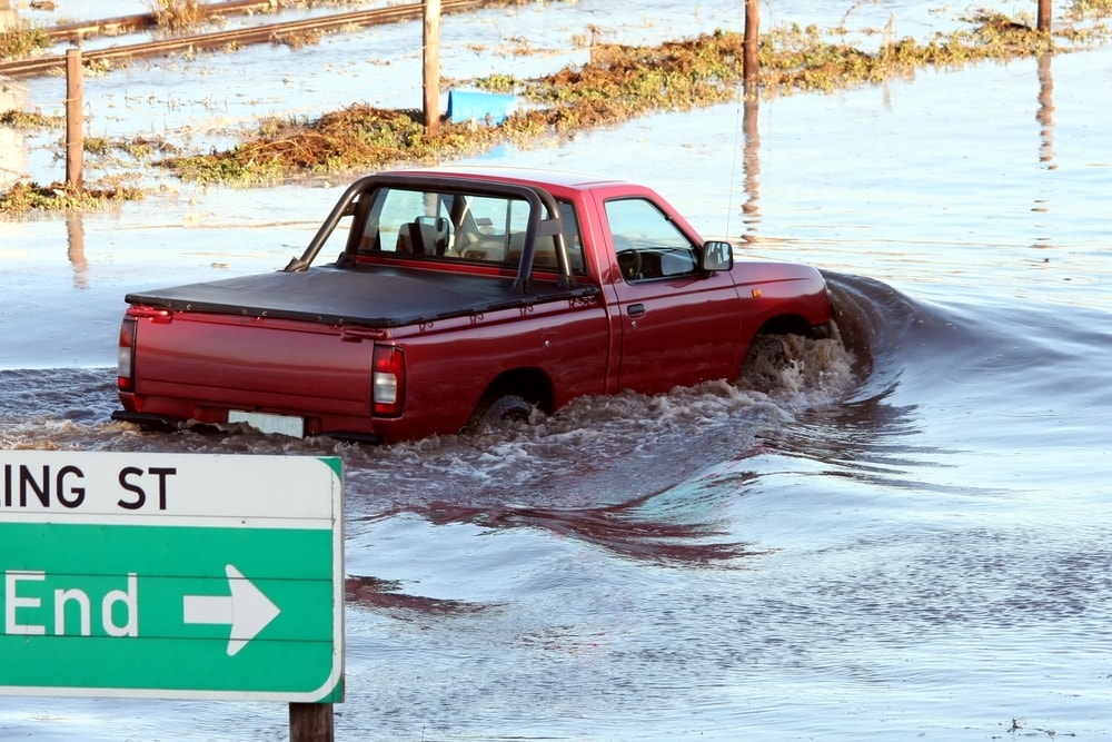 red truck driving through water