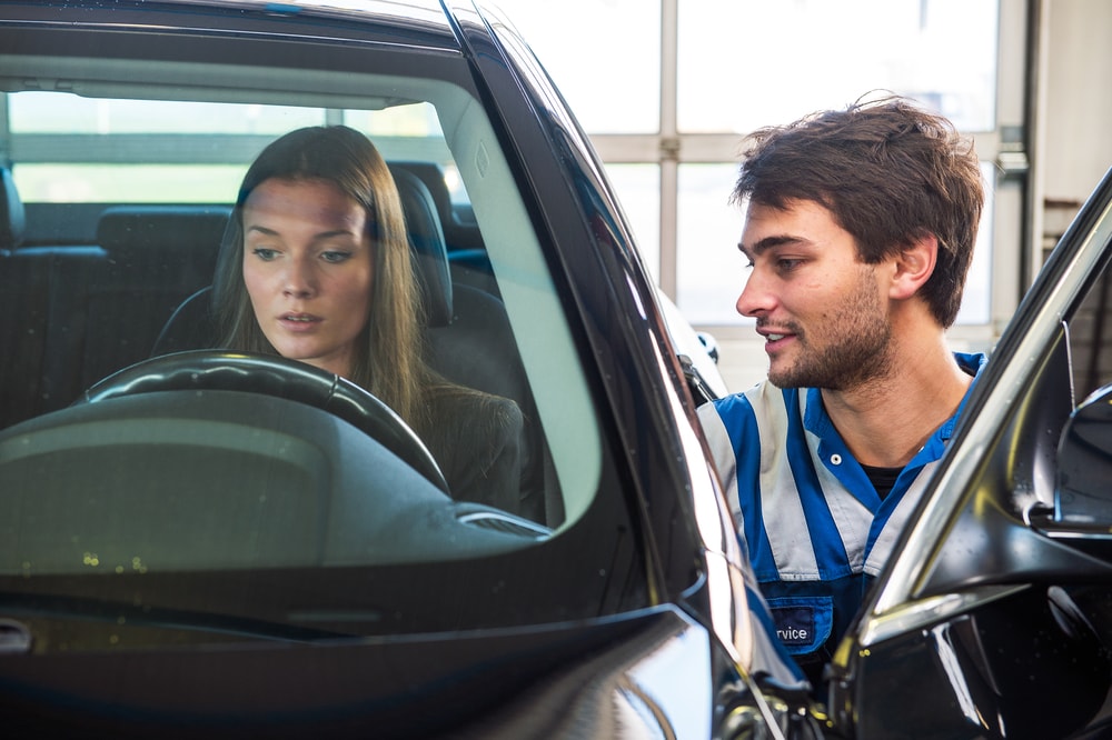 woman having a car inspected