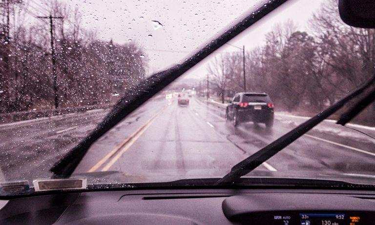 An image of a car's windshield wiper blades being used during a rainstorm. You can get a free wiper blade set replacement and other one-time services with an Advantage auto protection plan from Endurance Warranty.