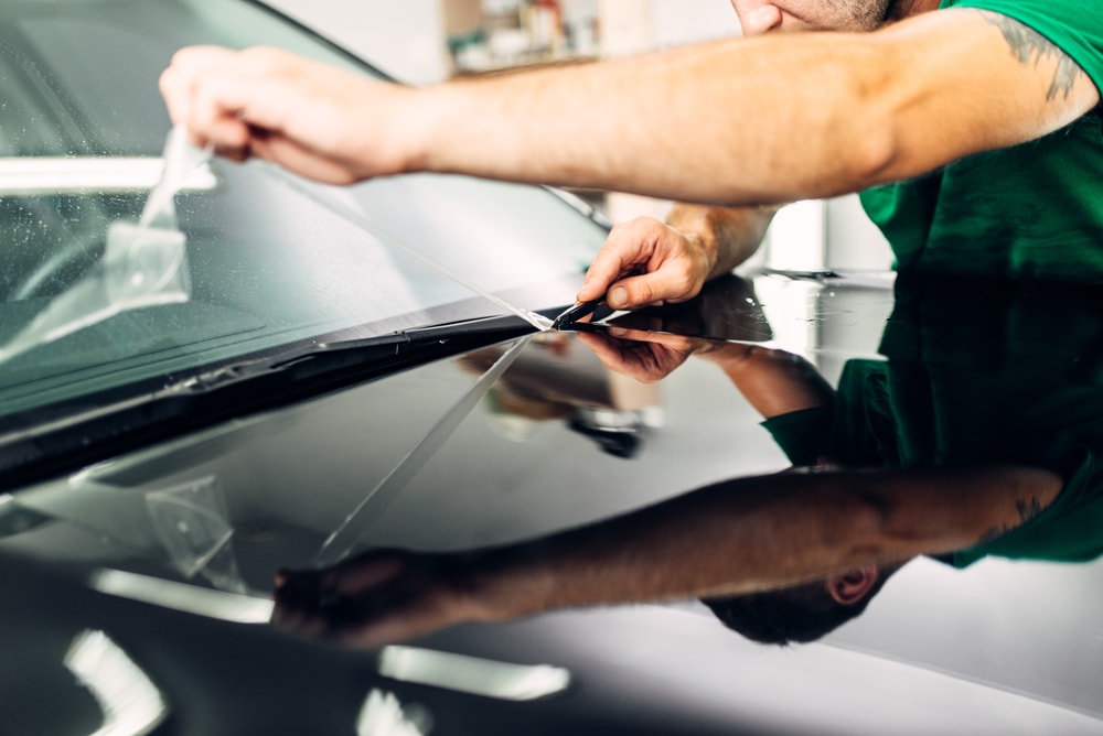 person installing car protection film