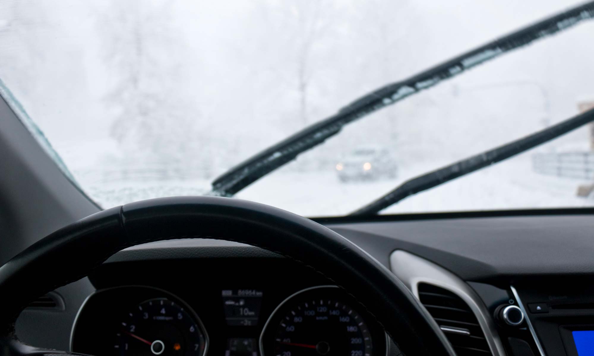 A cloudy windshield during the winter.