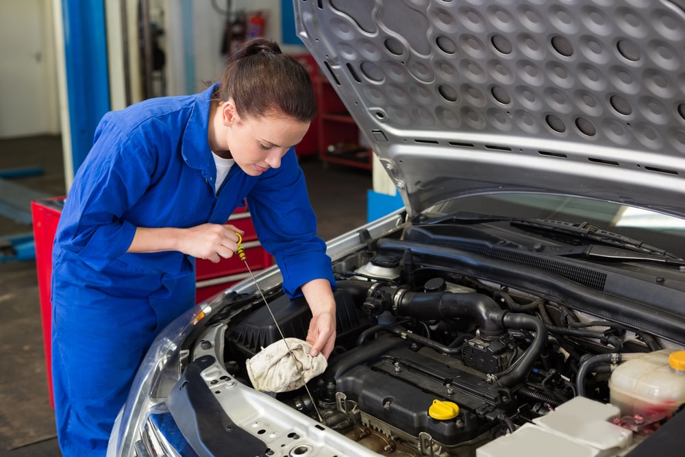 mechanic checking fluids