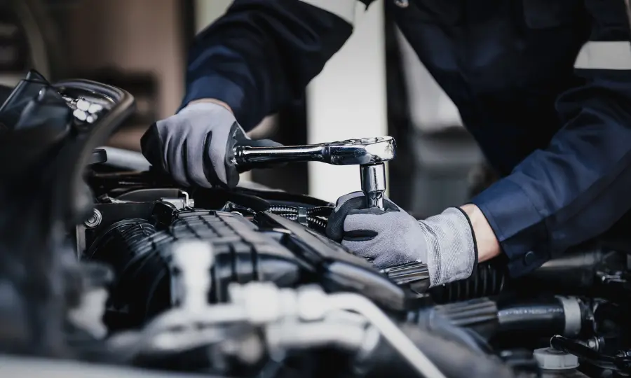 Professional mechanic working on the engine of the car