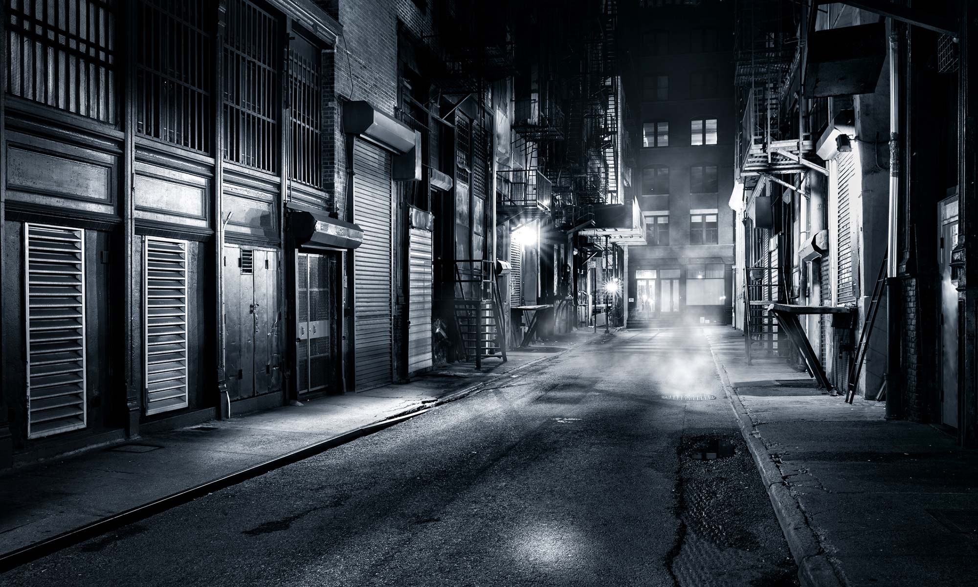 An alley of Gotham City in black and white.