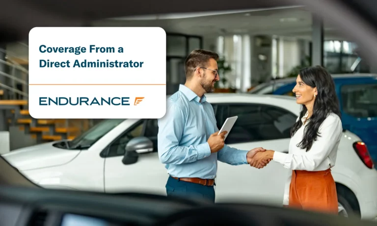 Buyer of the car shaking hands with the seller at a dealership