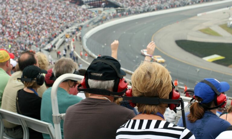 Crowd of people watching a Nascar race at a racetrack