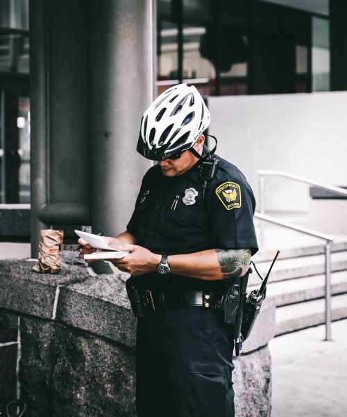 Uniformed Policeman Writing Ticket