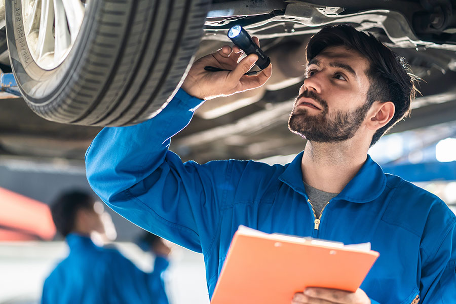 A mechanic checking a car