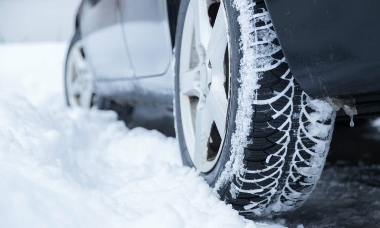 A car's tires in the snow.