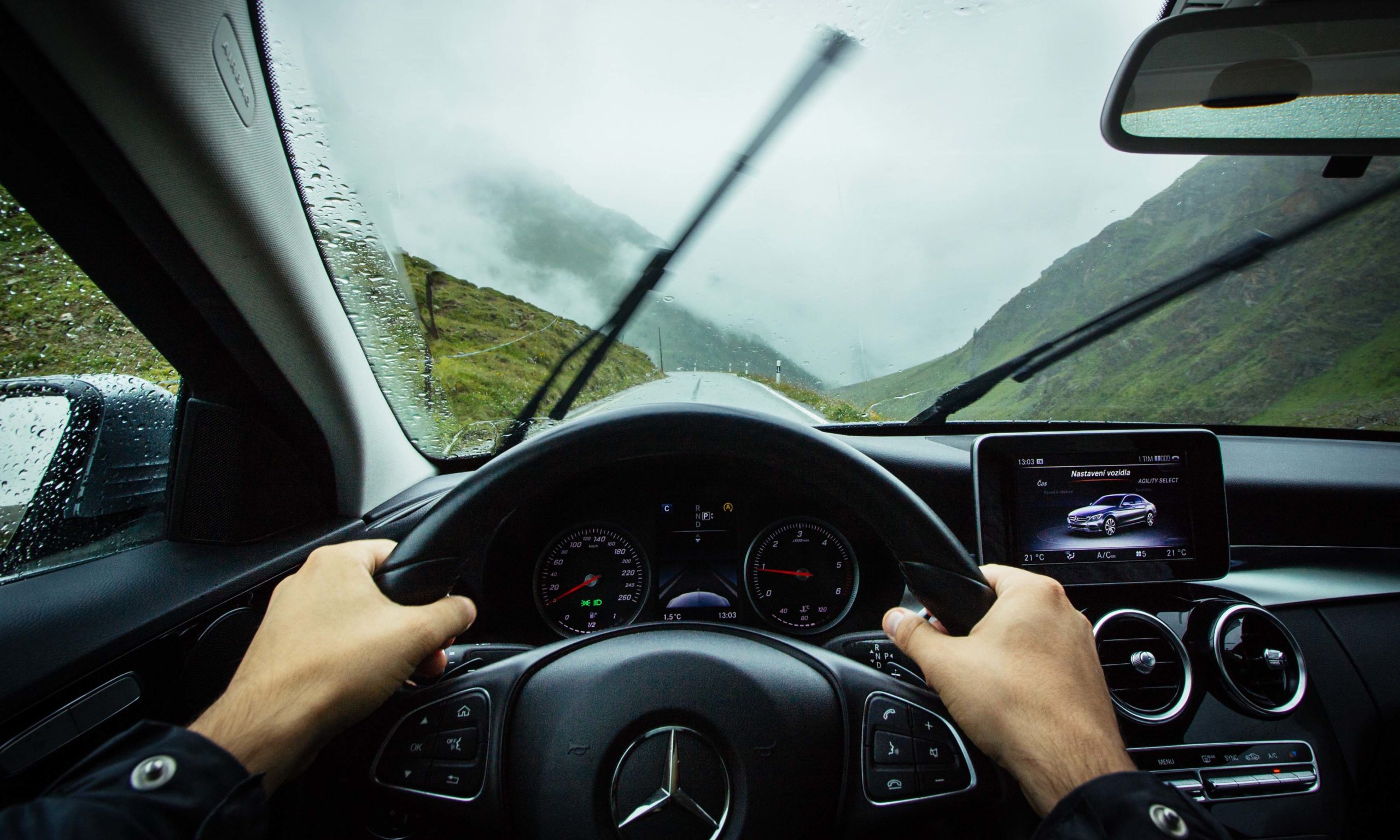 Car driving in rain using wipers