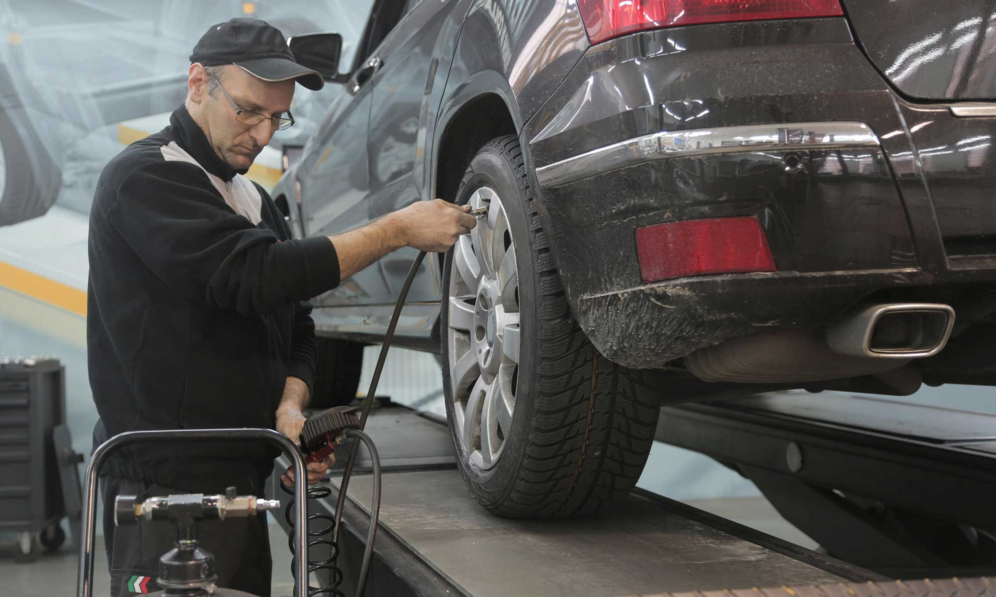 A mechanic checking tire pressure.