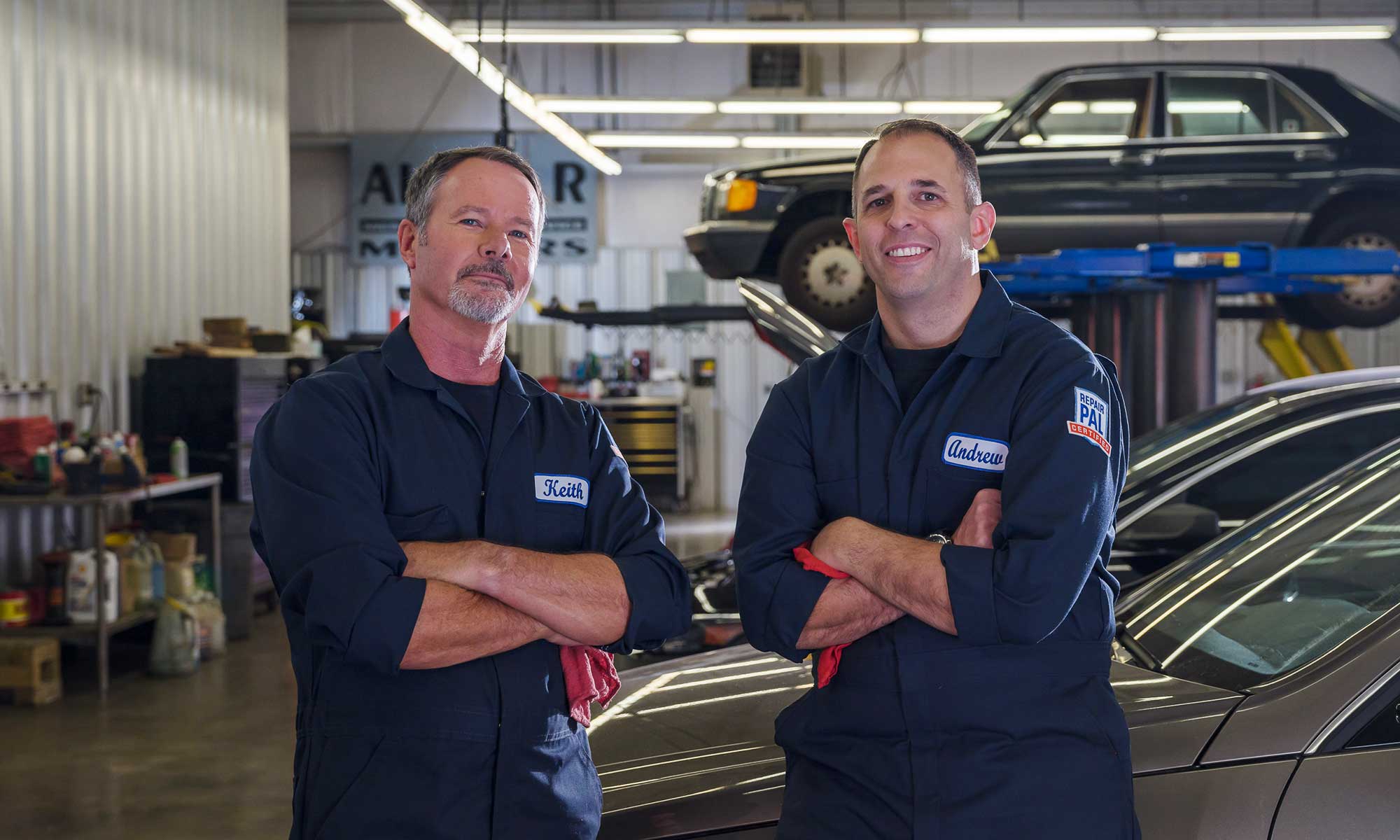 Two certified mechanics, Keith Benline and Andrew Giorgi, at a repair shop.