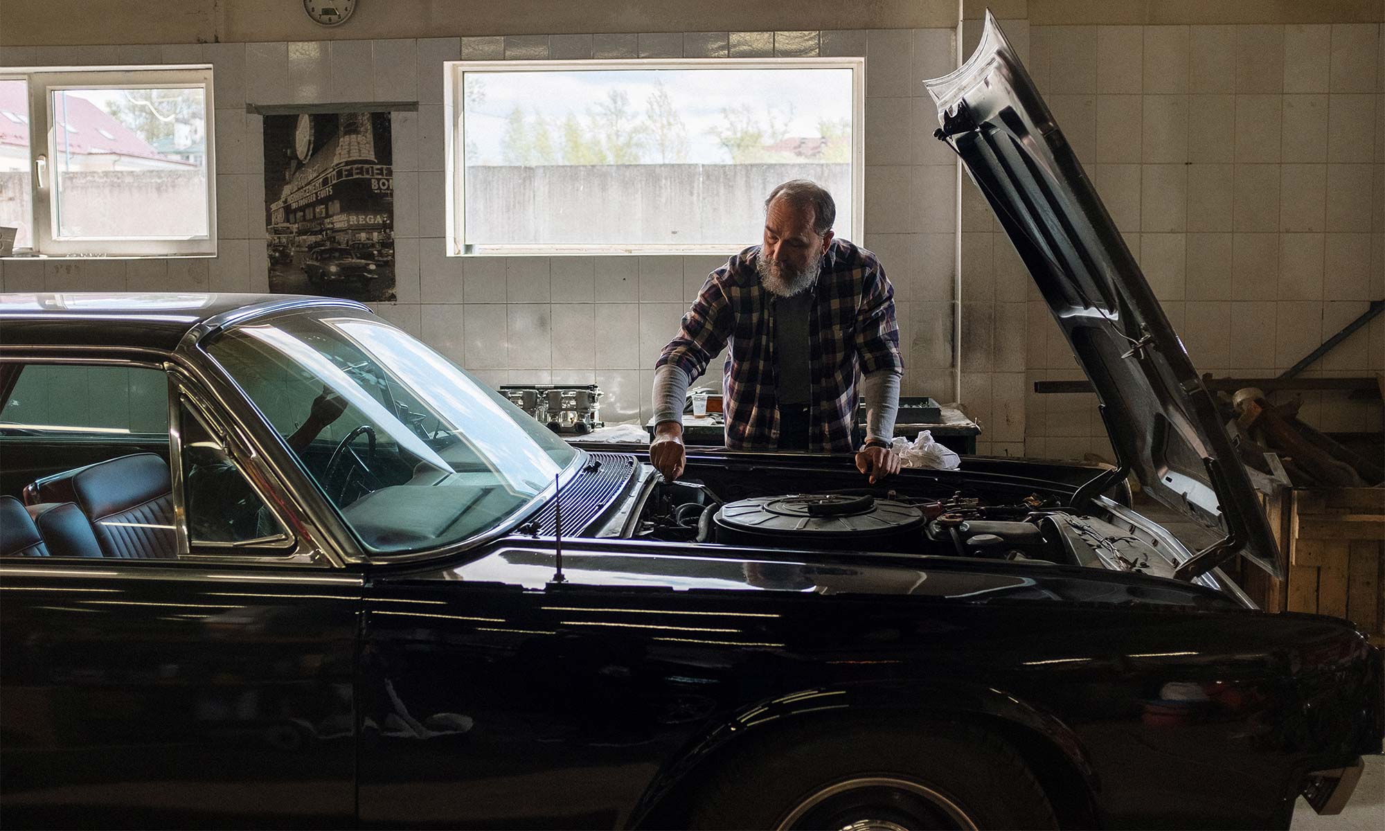 A man working on his car's engine