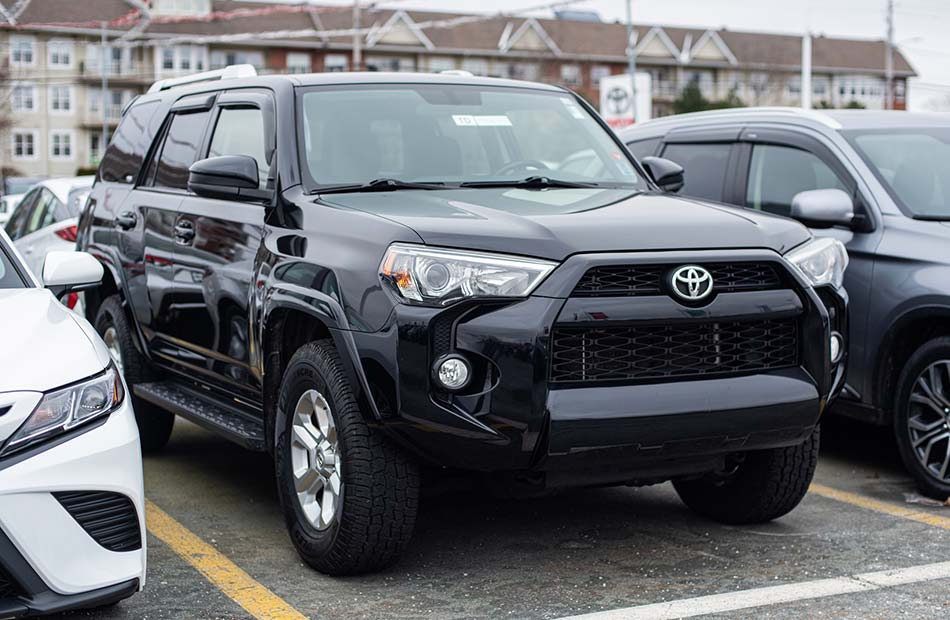 A black Toyota 4Runner parked in a parking lot.