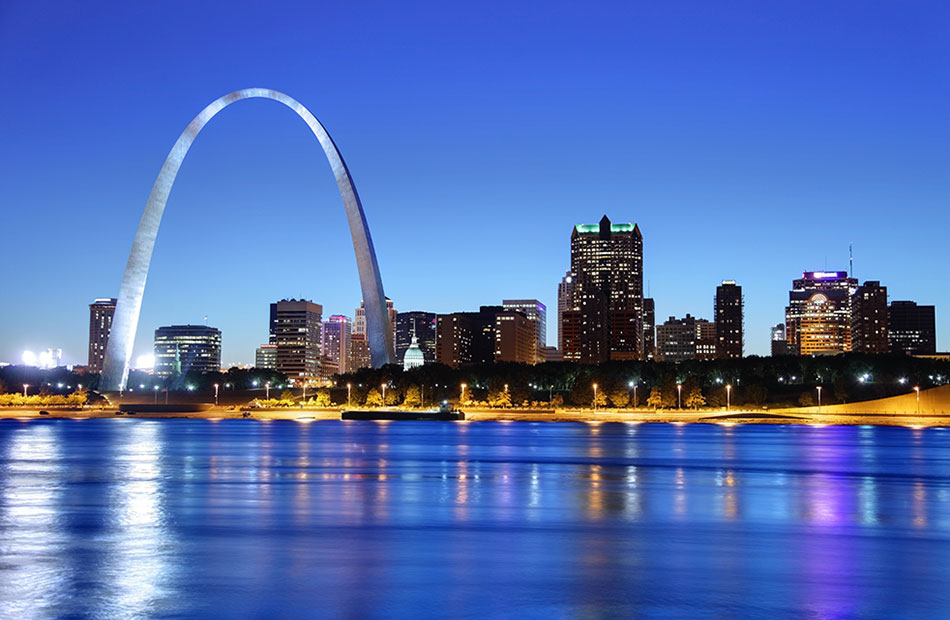 An image of the Gate Arch and St. Louis skyline illuminated at night.