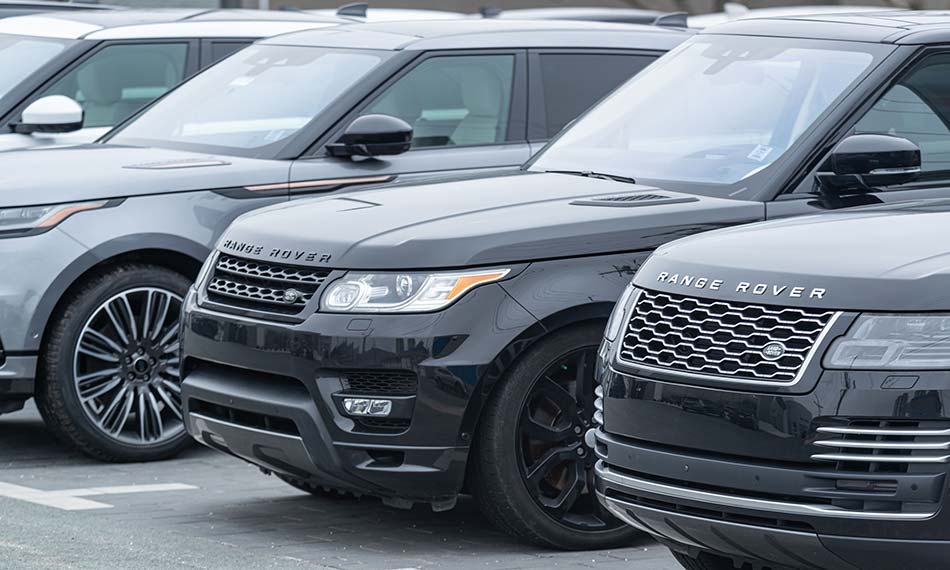 An image of three Range Rovers parked next to each other.