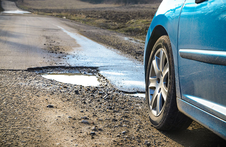 A pothole in the road. 