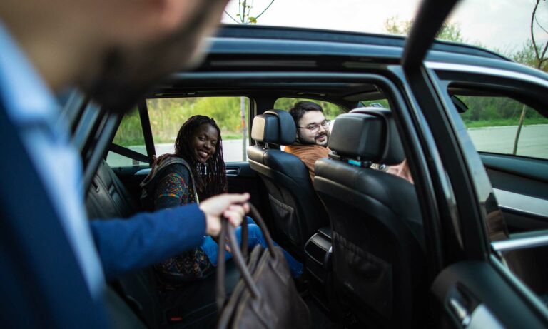 A man getting into a rideshare vehicle.