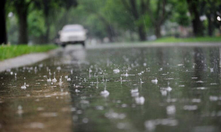 A car parked in the rain.