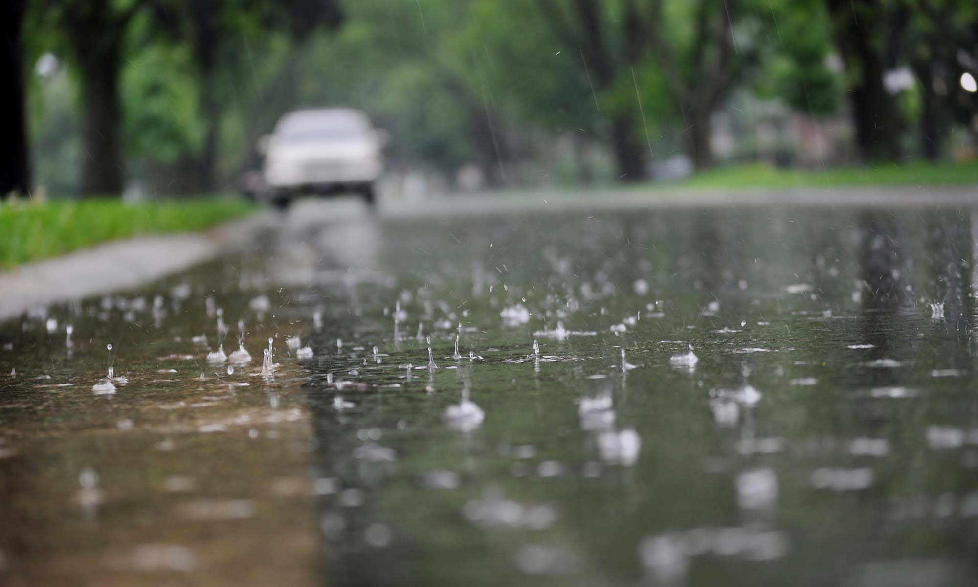 A car parked in the rain.