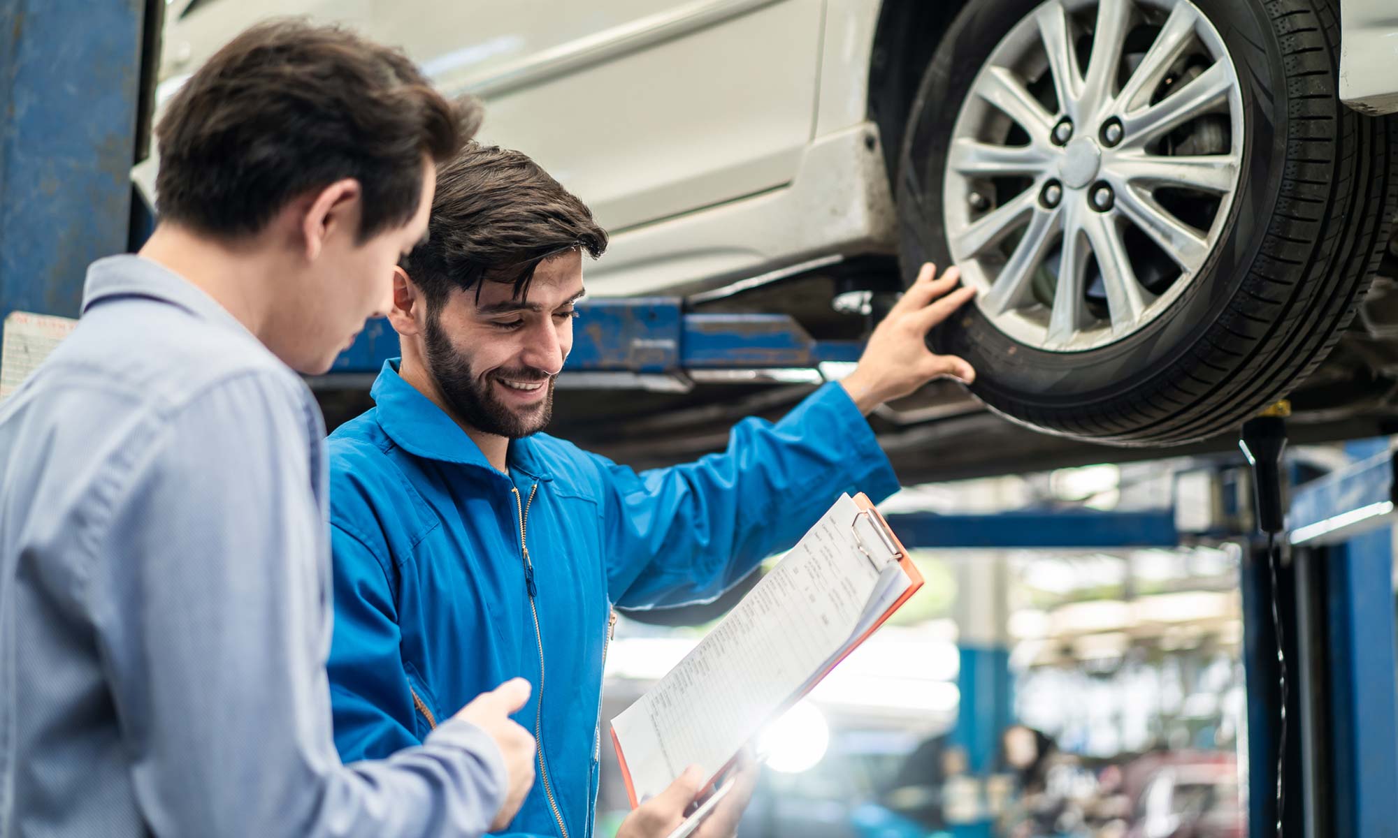 A mechanic speaks to a customer.