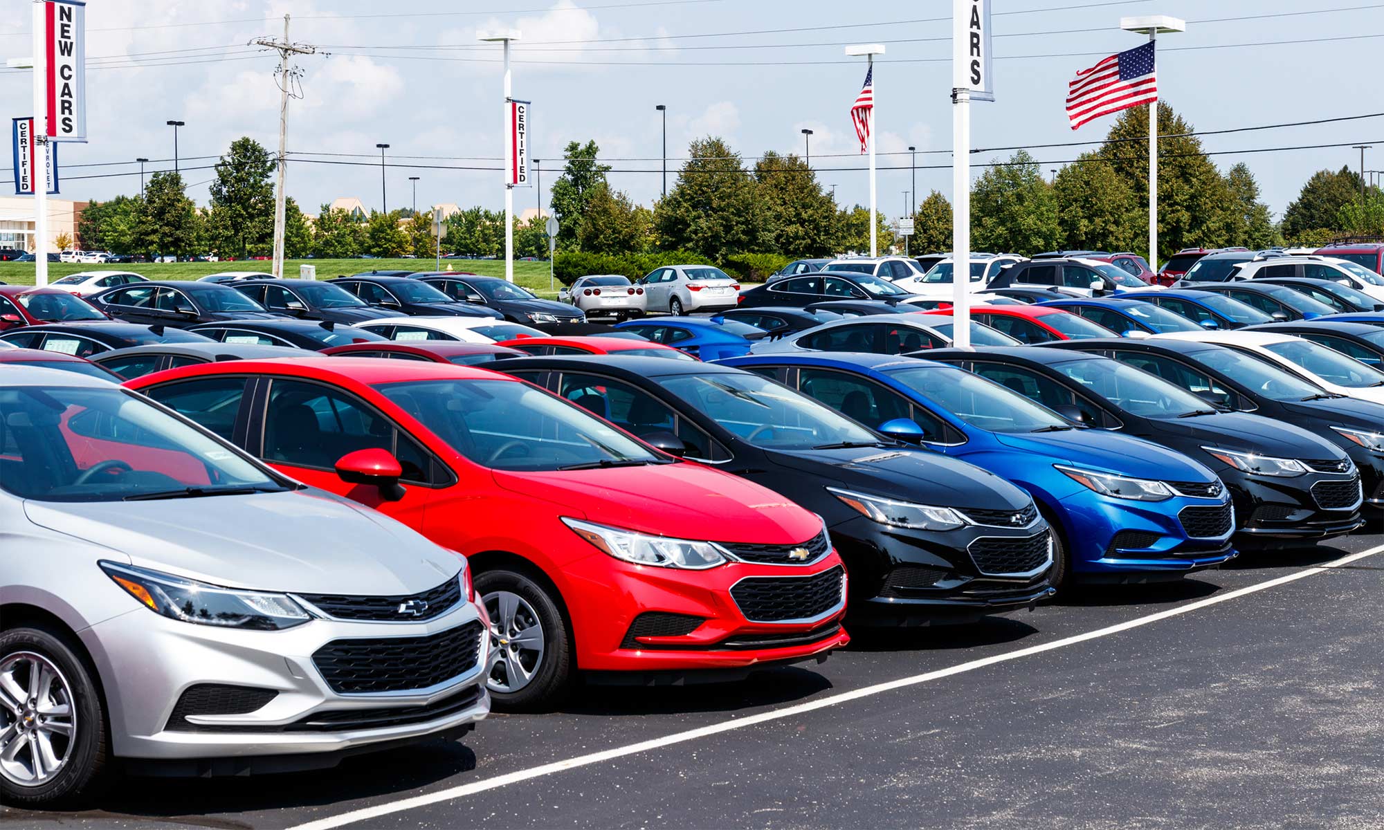 A row of cars at a dealership.