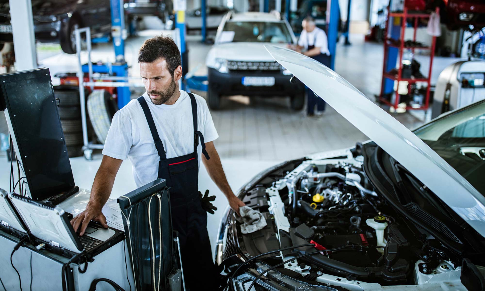 Mechanic performing engine diagnostic check.