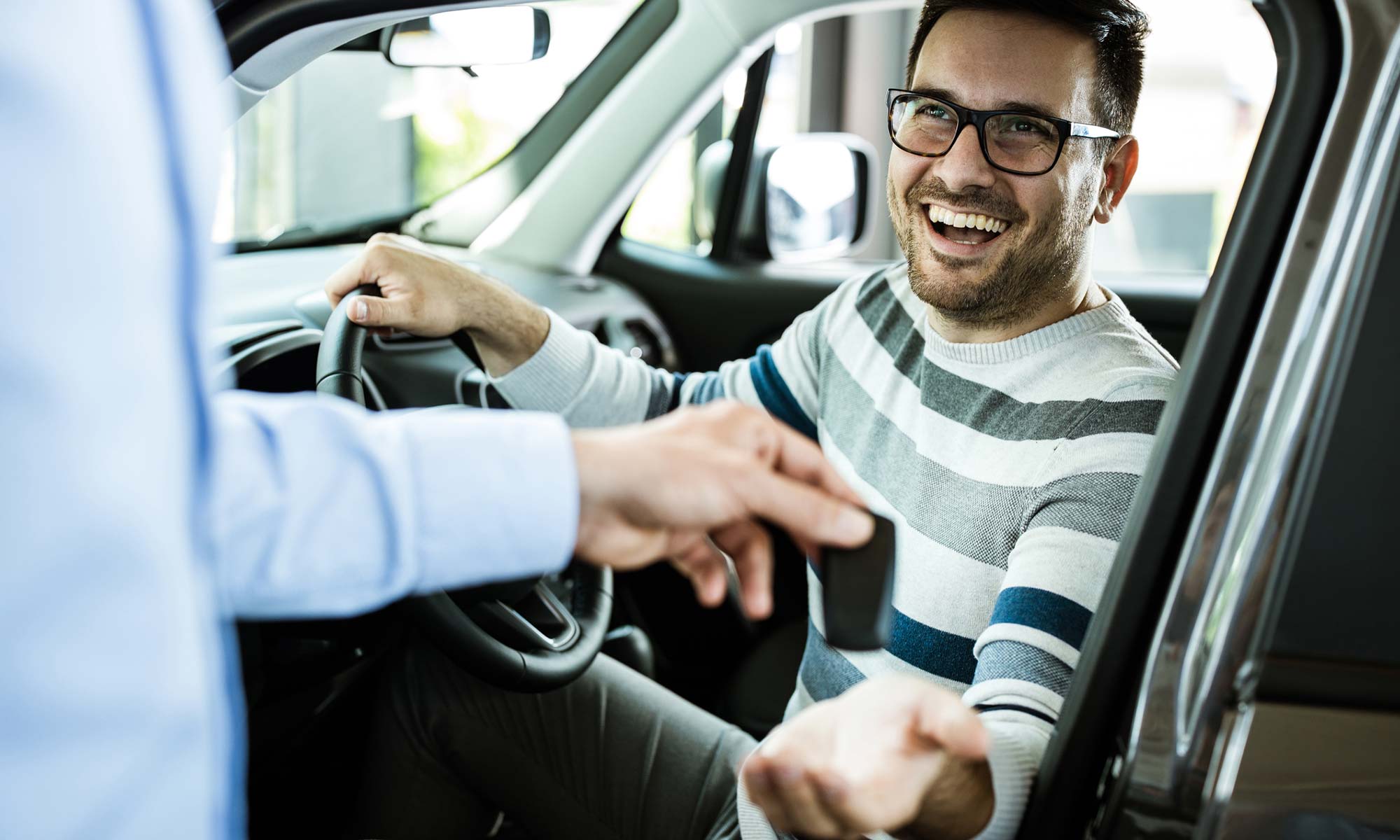 A young man purchasing a new car,