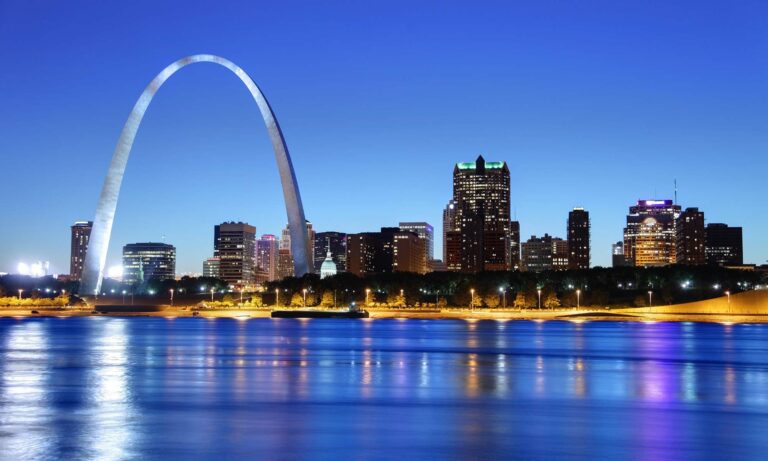 An image of the Gate Arch and St. Louis skyline at night.