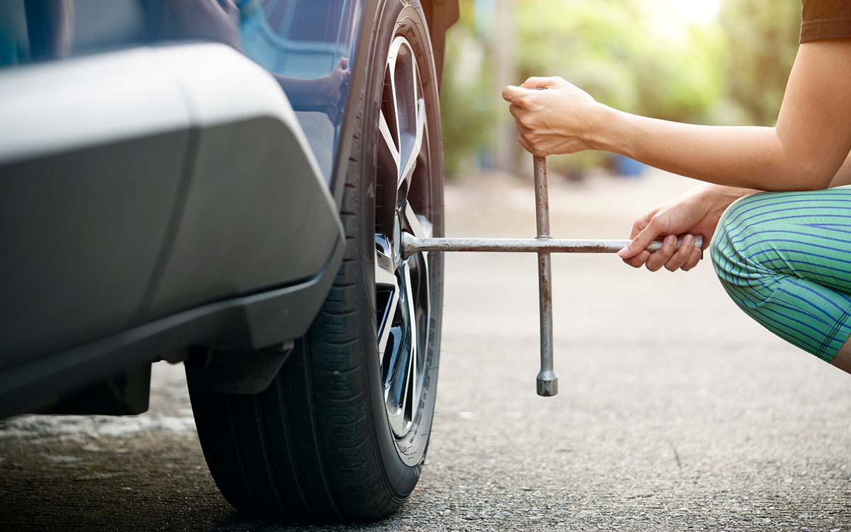 A woman changing a vehicle