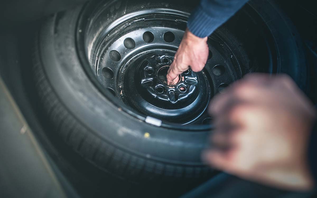 A spare tire in a trunk.