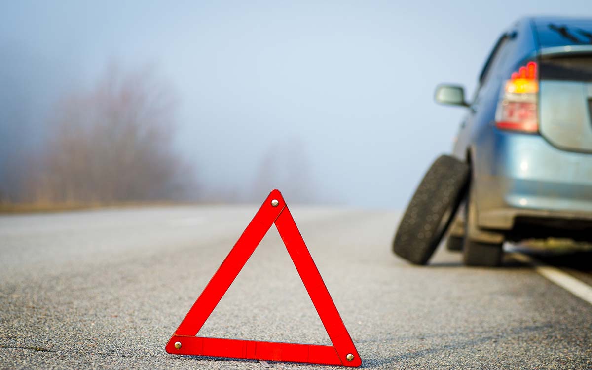 A vehicle pulled over with a flat tire.