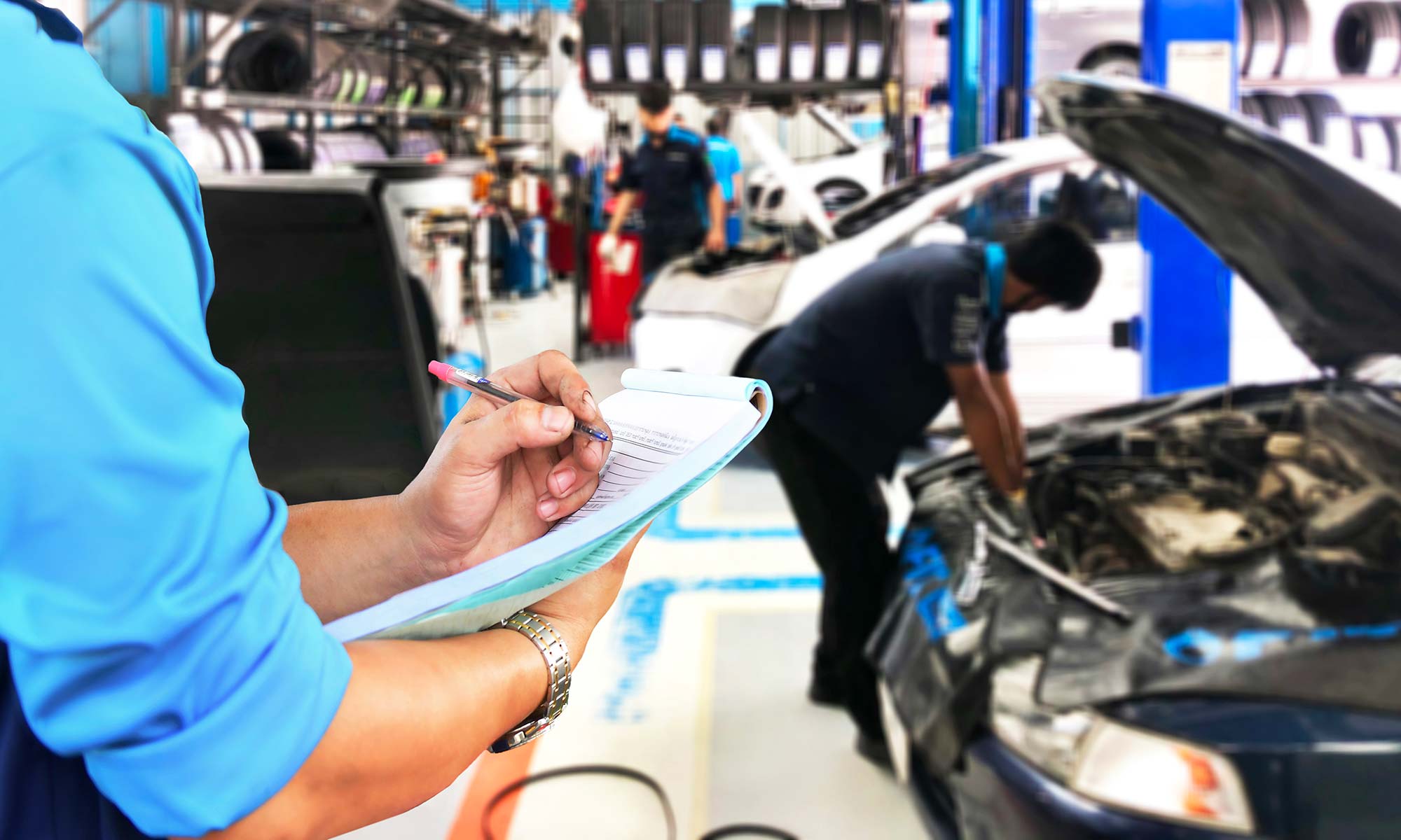 A mechanic checks his clipboard.