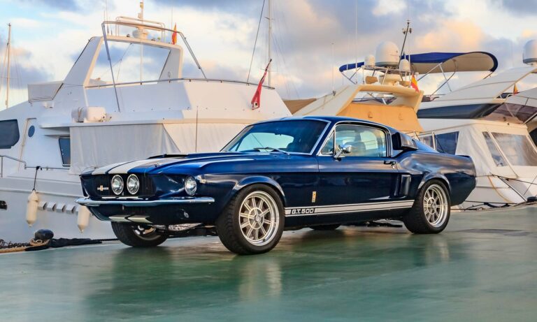 A blue Shelby GT500 car on pier..