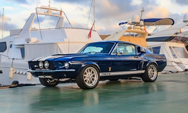 A blue Shelby GT500 car on pier..